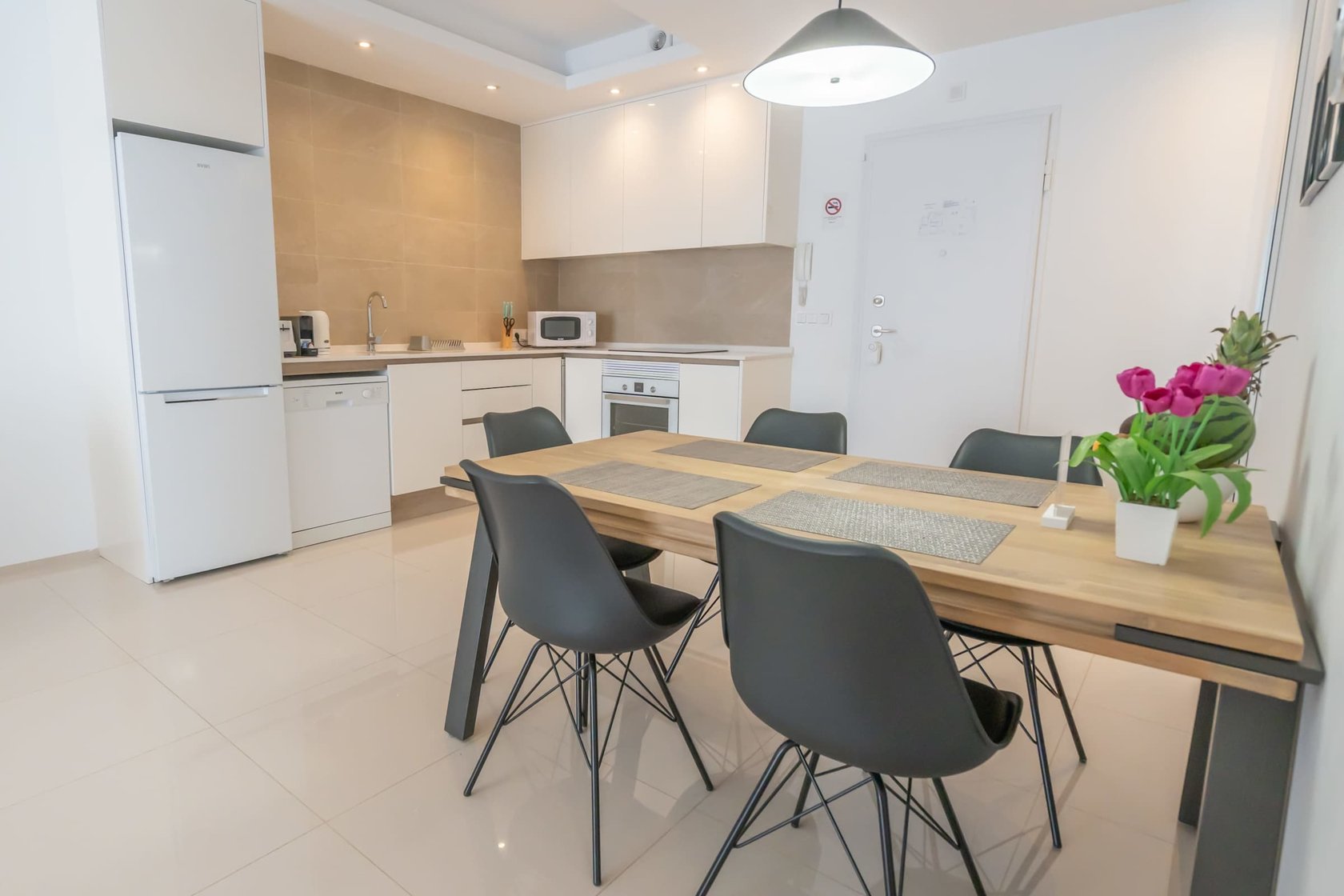 Kitchen with Dining Table, Oven, Stovetop, Microwave, Dishwasher, Fridge and Toaster