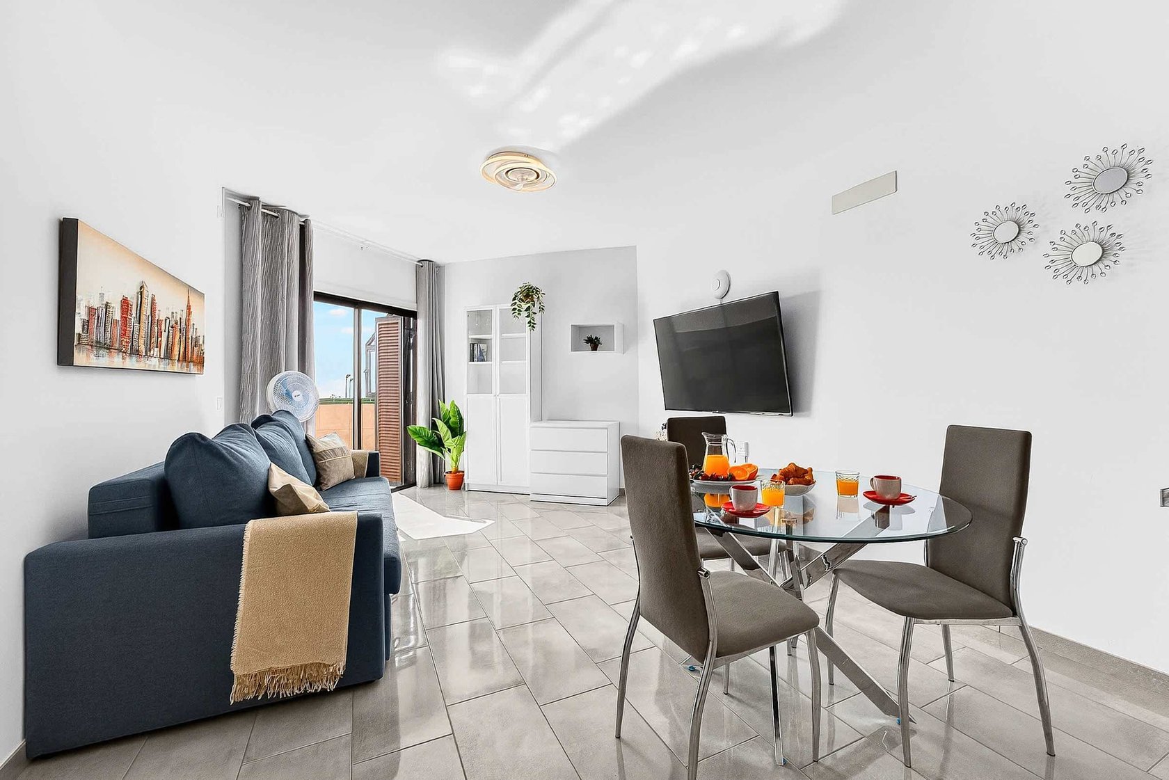 Livingroom with Dining Table, Sofa Bed, Flatscreen TV, and Balcony View
