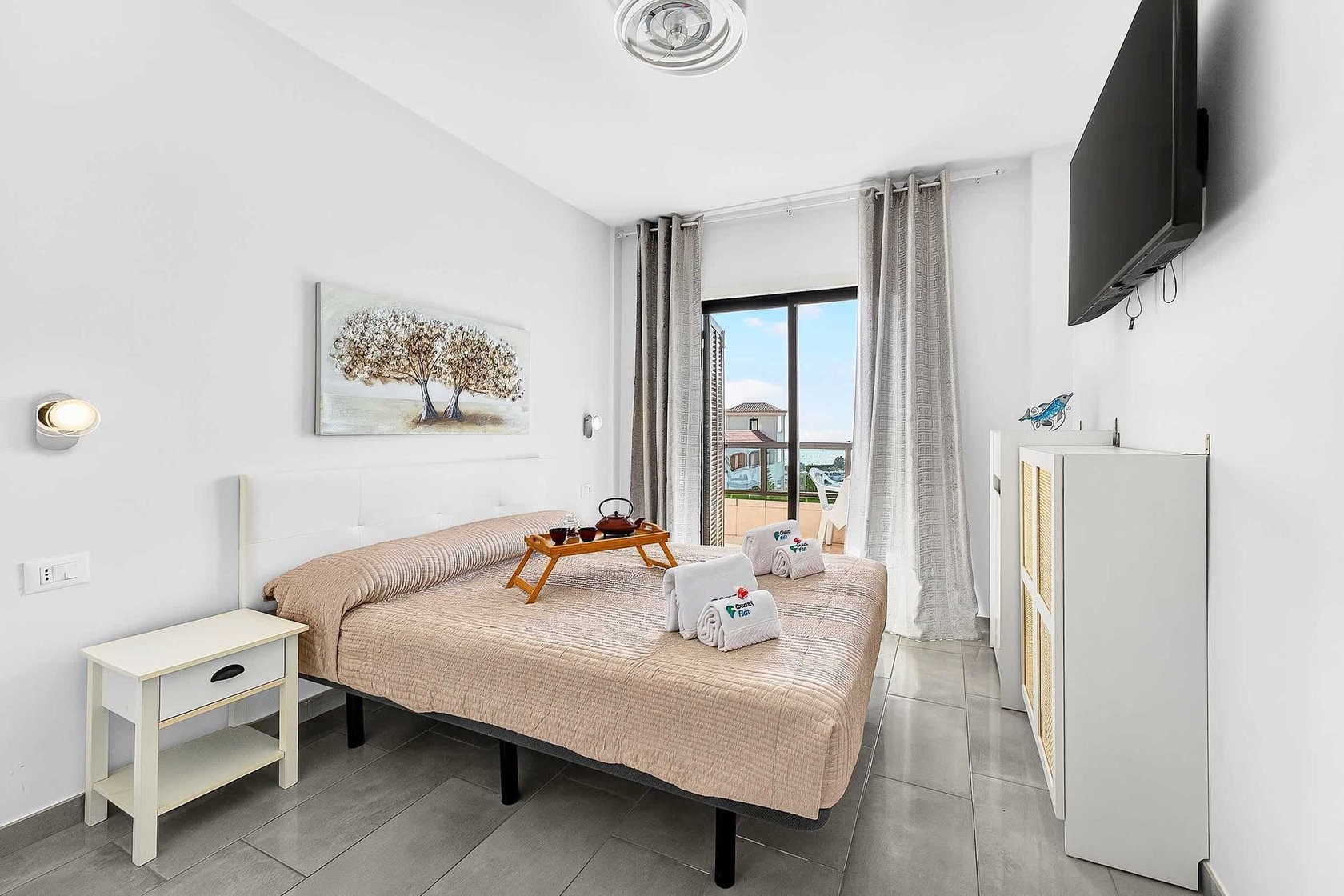 Bedroom with Queen Bed, Flatscreen TV, Wardrobe and Balcony Access