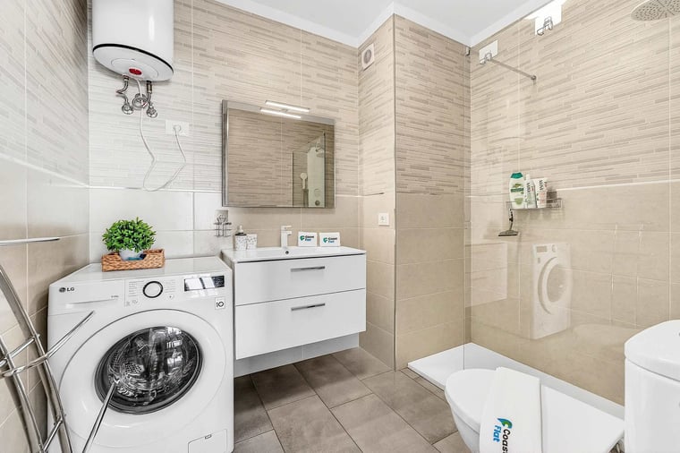 Bathroom with Toilet, Multi-Jet Shower, Sink and Washing Machine 