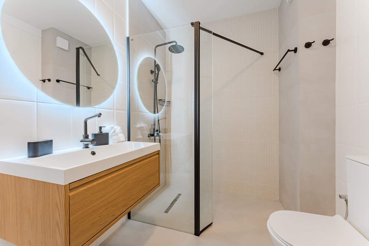 Contemporary Bathroom Featuring Walk-In Rain Shower, Backlit LED Mirror, and Sleek Designer Fixtures
