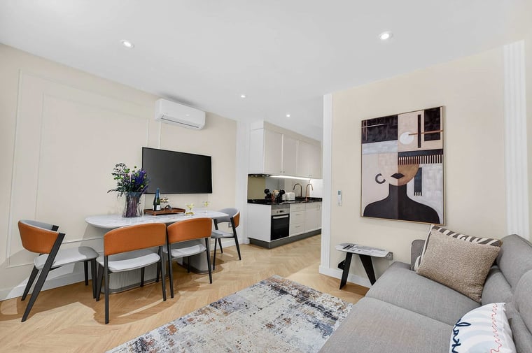 Elegant Open-Concept Living and Dining Area — Relax in Contemporary Comfort with a Designer Sofa, Smart TV and Ocean Breeze Ambience