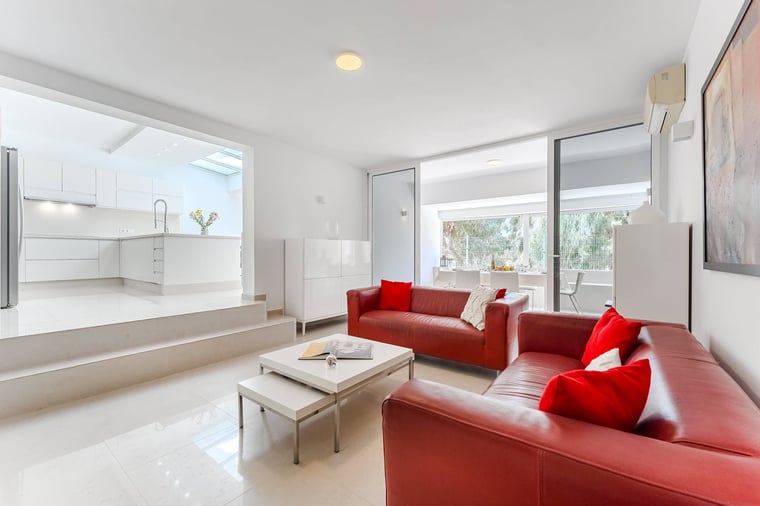 Bright Living Room with Bold Red Sofas, AC and Terrace Views – A Chic Lounge Space Designed for Comfort and Connection