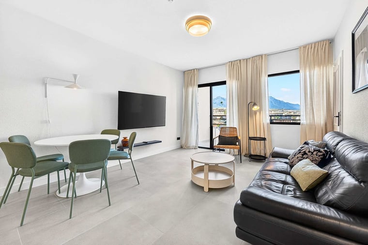 Bright Living Room with Balcony Access, Mountain Views & Cozy Seating