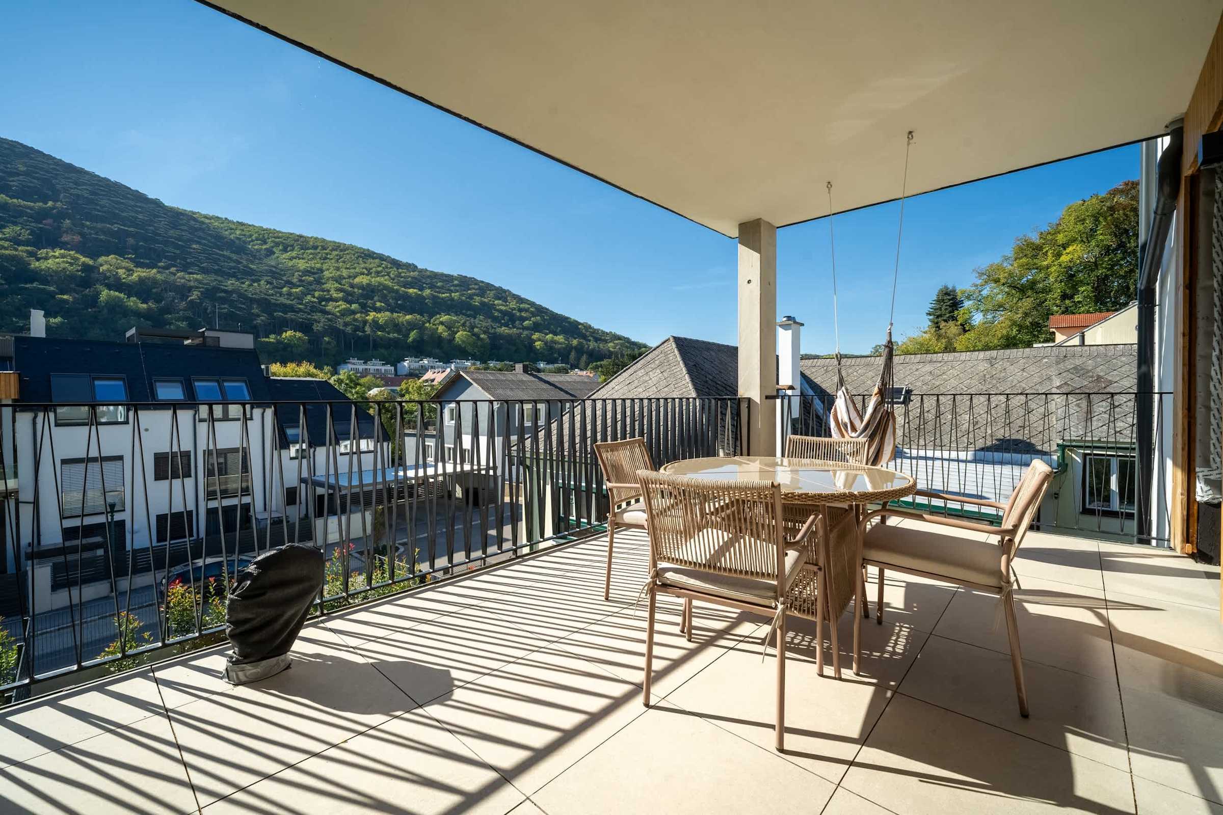 Balcony dining table with hill views