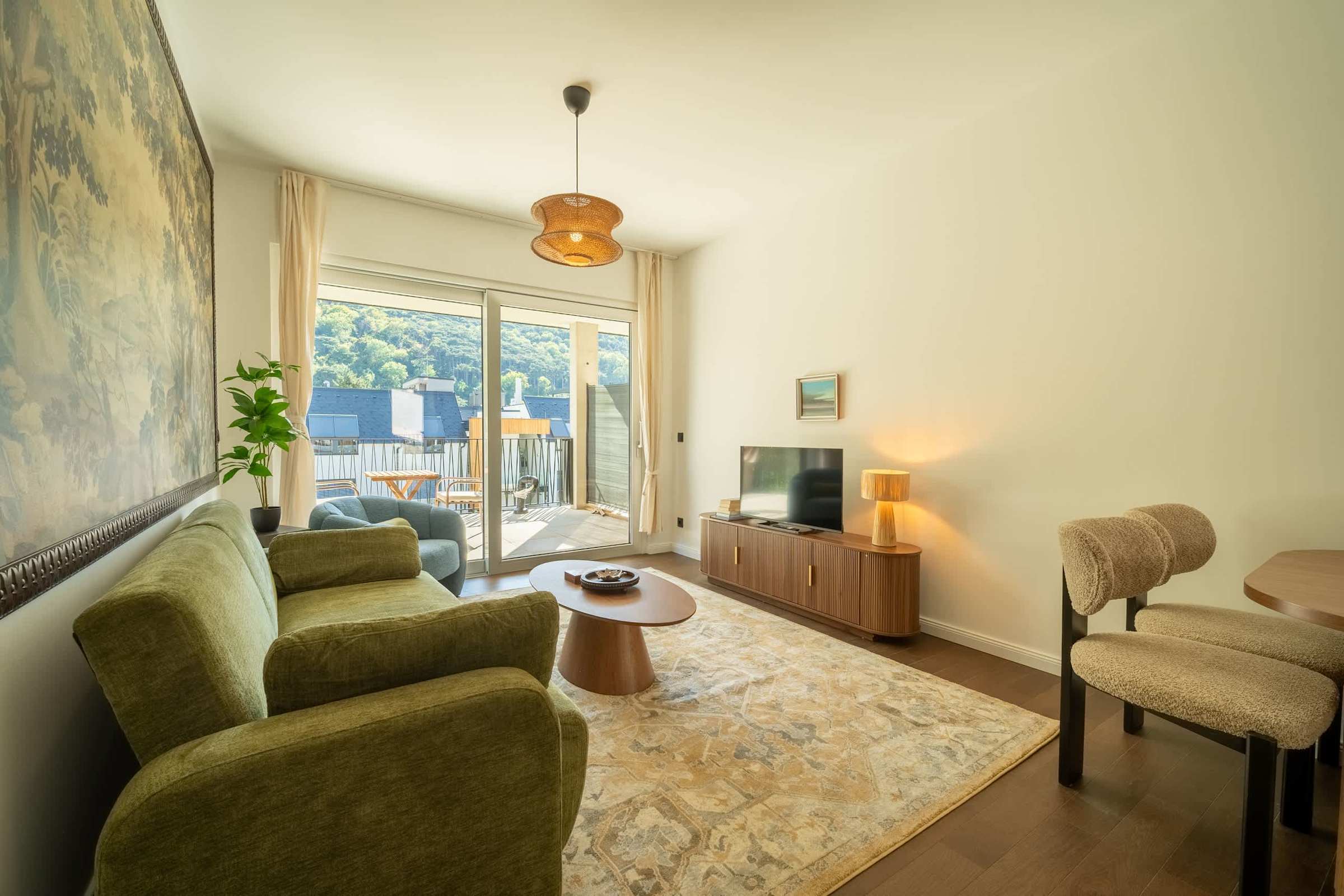 Living room with TV and doors to the balcony