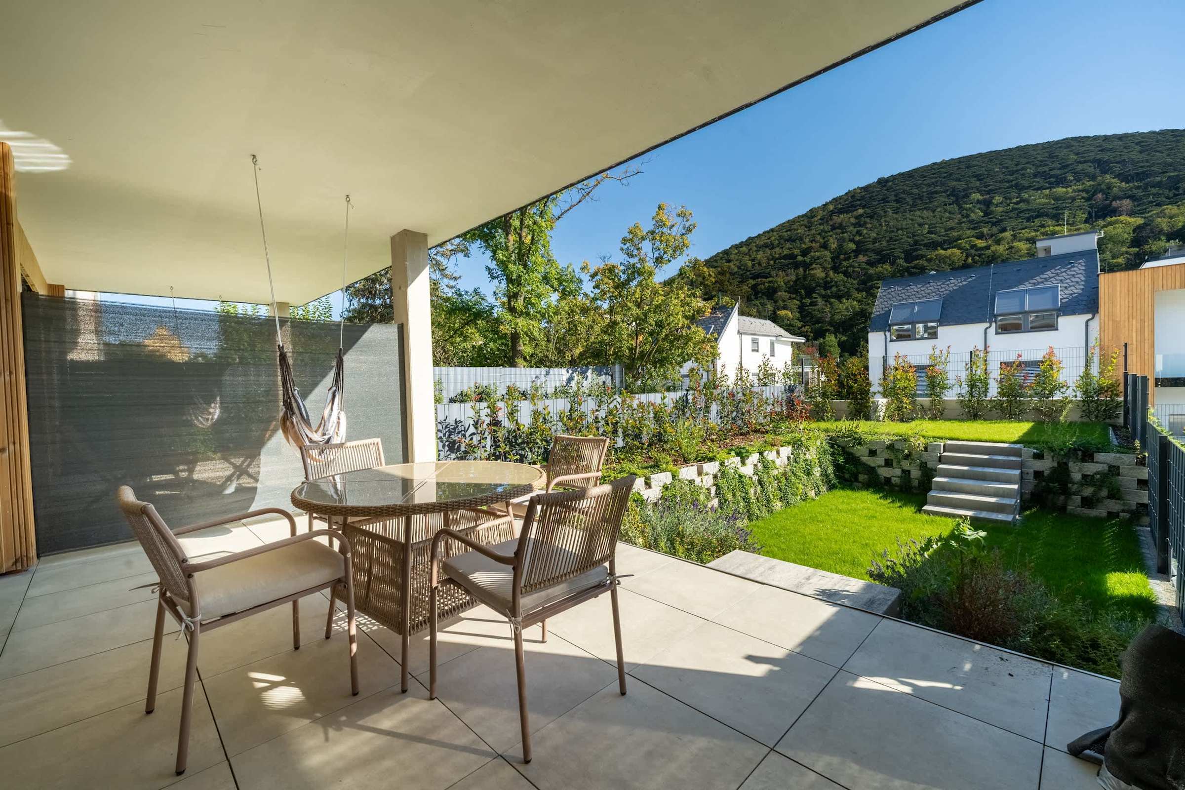 Covered terrace with outdoor dining, opening onto the private garden