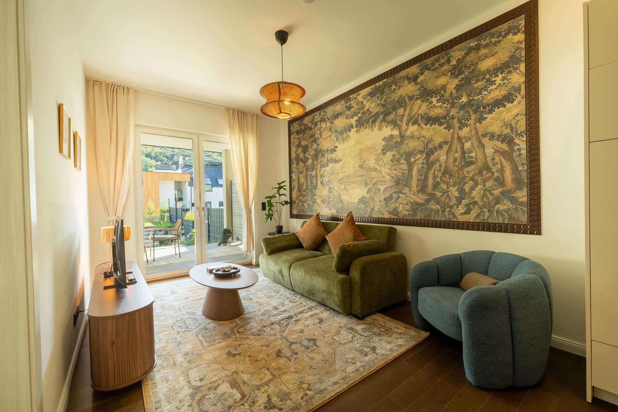 Living room with sofa bed, TV and doors to the terrace