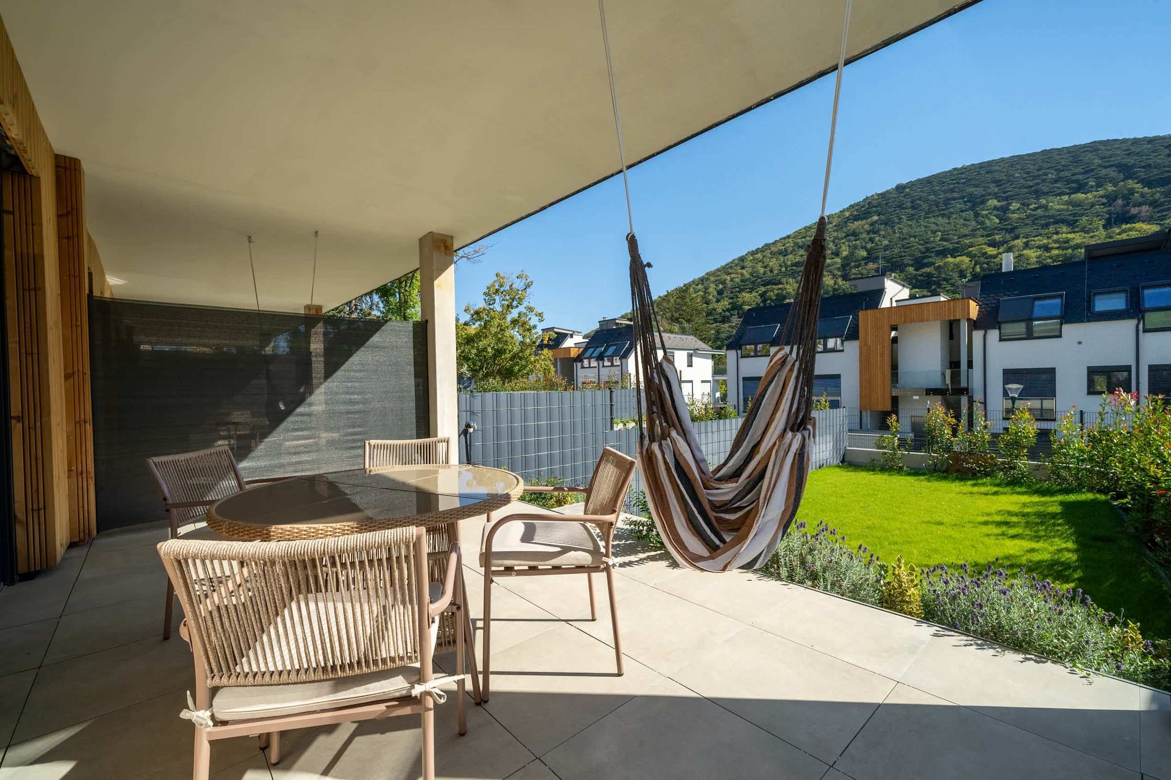 Terrace with hanging chair and hill views