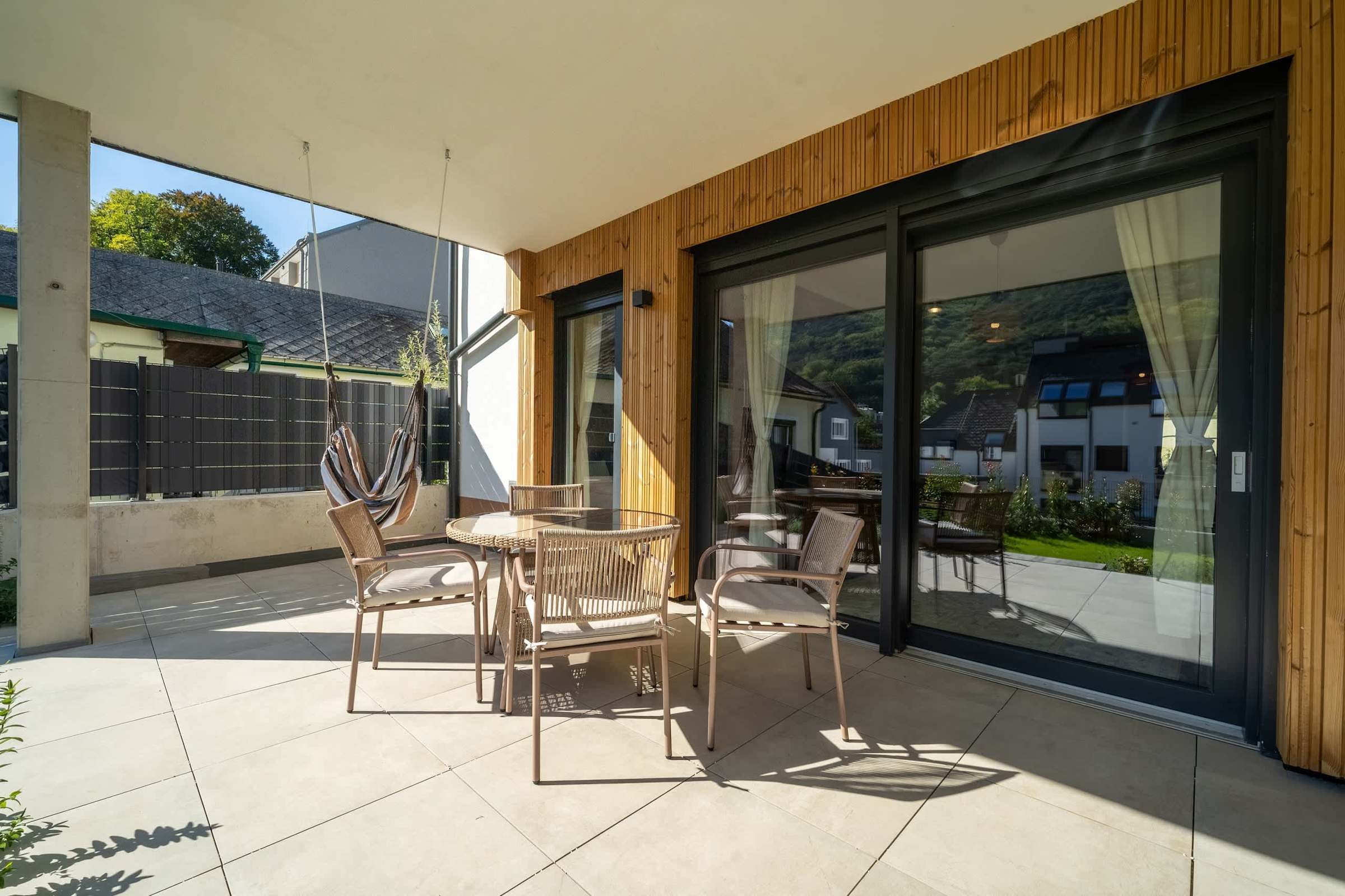 Terrace with dining set and hanging chair