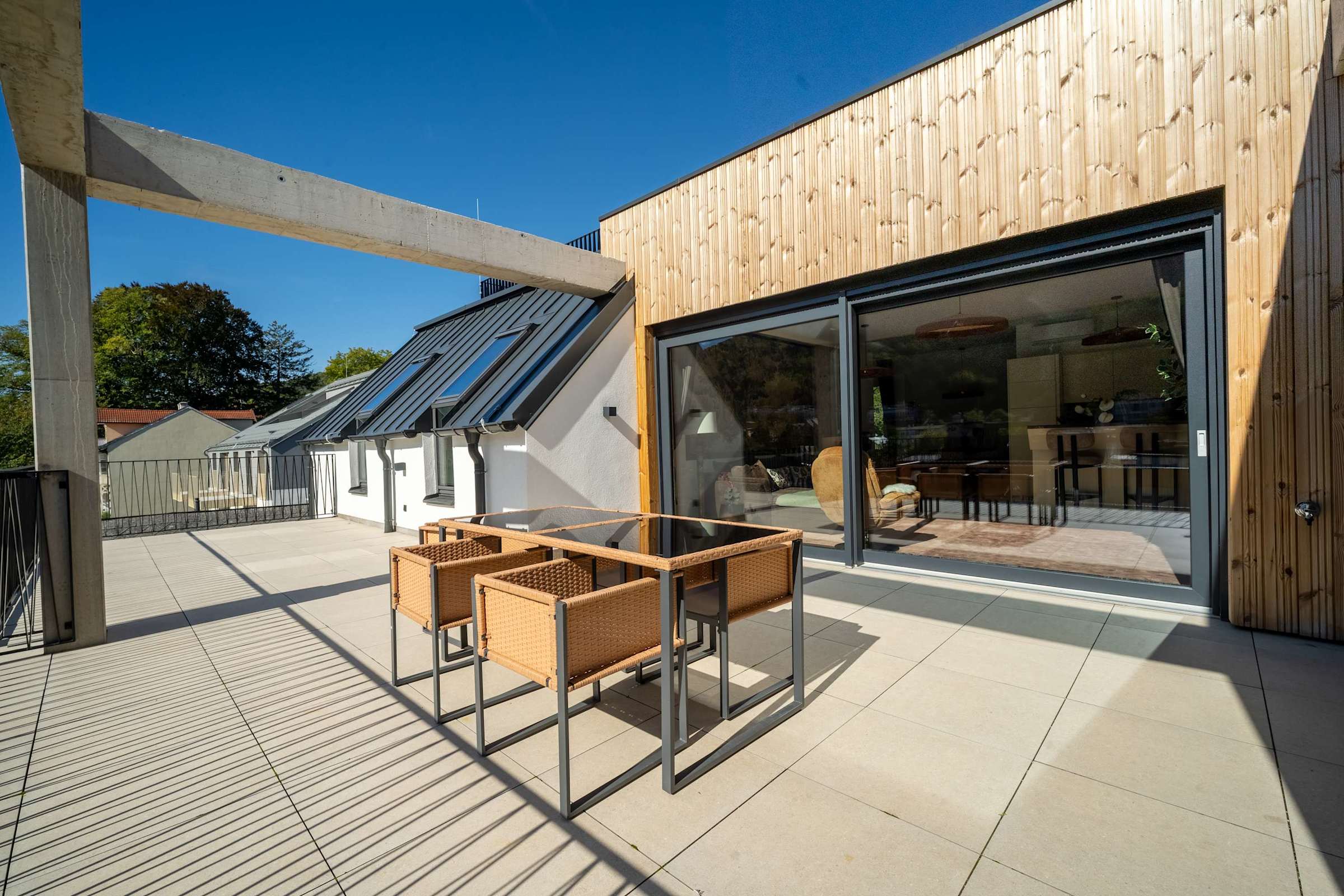 The terrace opens directly from the living room through large sliding doors